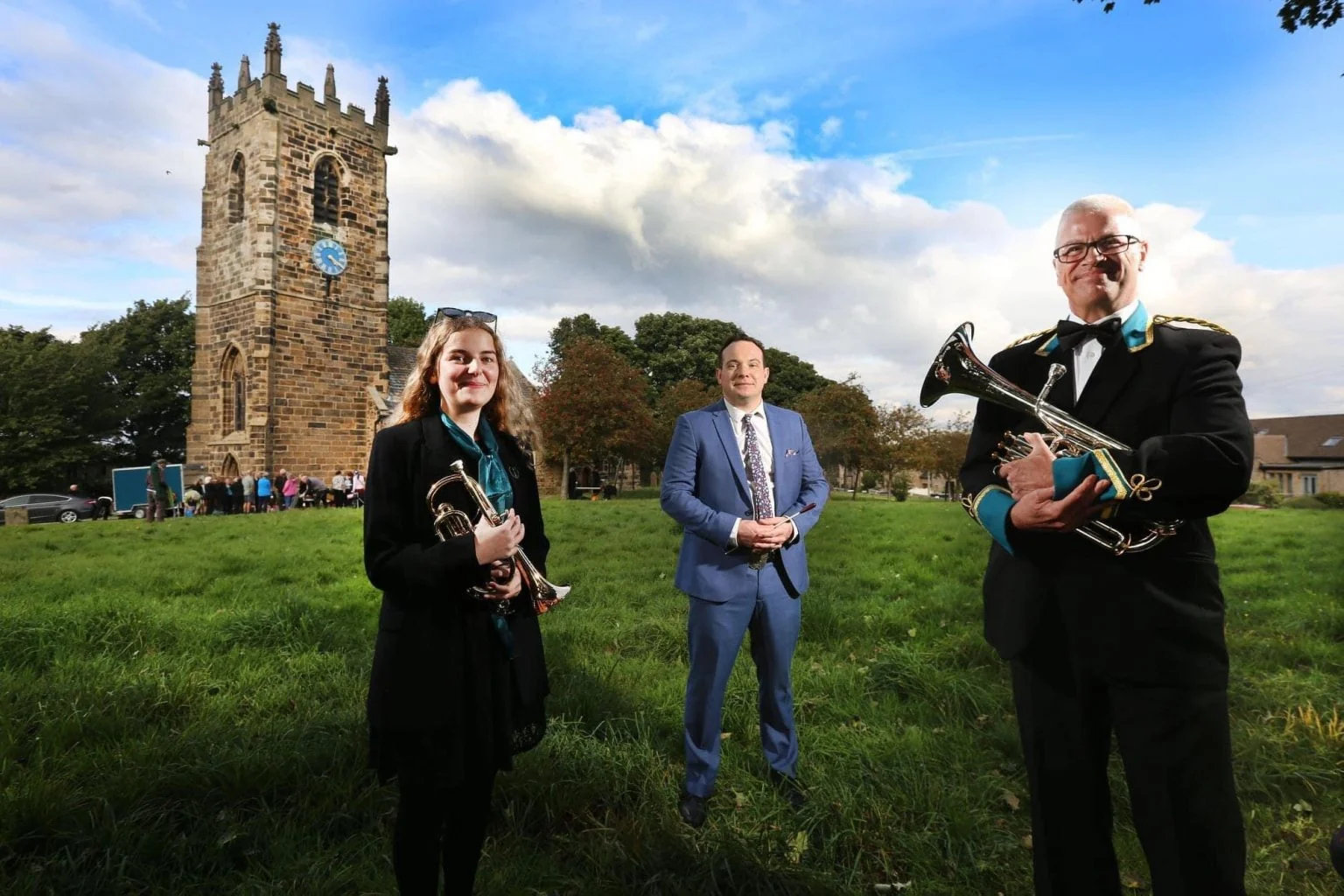 Band members with their instruments in the grounds of St Michael’s Church, Emley.